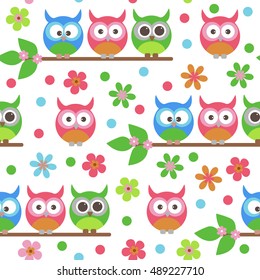 Vector seamless texture children. Owls sitting on a branch among flowers.