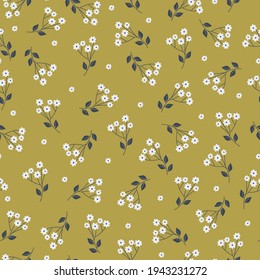 Vector seamless vintage pattern. mustard background ,small white flowers. fabric print, scrapbooking paper, gift wrapping, and wallpaper.