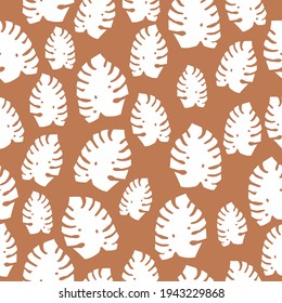 Vector seamless vintage pattern. terracotta background ,white monstera leaves. fabric print, scrapbooking paper, gift wrapping, and wallpaper.