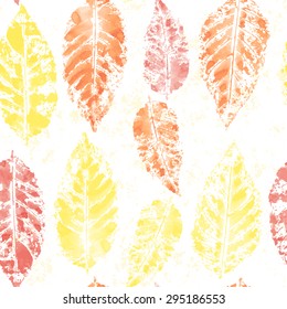 Vector seamless watercolor pattern with bright yellow, orange and red imprints of leaves 