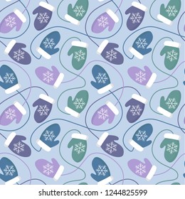 Vector seamless winter pattern with colorful mittens on blue background. Perfect for wrapping paper pr fabric. 