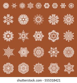 Vector set of abstract hand drawn snowflakes maked on a brown background. Hand painted sketch.