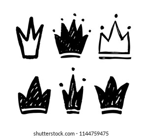 Vector set of abstract silhouettes of crowns. Hand drawn grunge icons isolated
