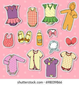 Vector set of baby clothes. Sticker style baby girl clothes set. Bright children clothes isolated on pink polka-dot background. Stylish baby clothes set.