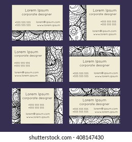 Vector set of black and white delicate hand drawn boho doodle paisley business card template designs. Floral business card templates for creative people.