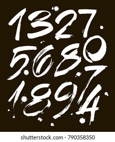 vector set of calligraphic acrylic or ink numbers. ABC for your design, brush lettering on a black background with blots