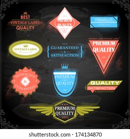 Vector set of calligraphic design elements: page decoration, Premium Quality and Satisfaction Guarantee Label, antique and baroque frames | Chalkboard background. Black illustration variant.