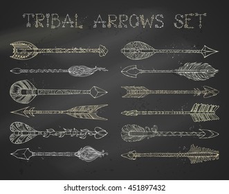 Vector set of chalk ethnic arrows on blackboard background. Hand-drawn tribal design elements. Boho and hippie style.