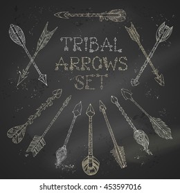 Vector set of chalk tribal arrows on blackboard background. Ethnic arrows sketch illustration. Boho and hippie hand-drawn style.