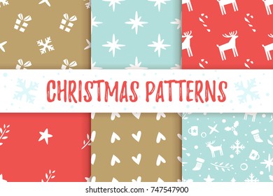 Vector set of Christmas and New Year red and blue seamless patterns with holiday symbols.