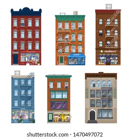 Vector set of different city buildings in Manhattan style with shops, stares, decoration elements. Shop fronts in living brick buildings. Pharmacy, gifts and antiques, laundry, cafe, book shop. Flat.