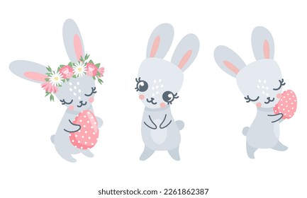 Vector set of Easter bunnies. Bunnies holding Easter eggs. Animals on white background 