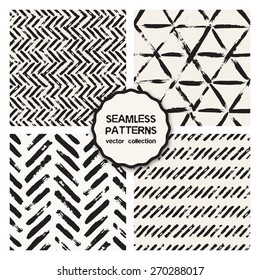 Vector set of four seamless patterns. Stylish collection with tileable swatches. Monochrome prints, backgrounds made with brush strokes: stripes, herringbone, zigzag, hipster triangles