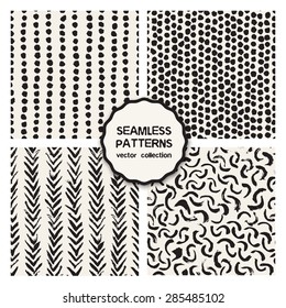 Vector set of four seamless patterns. Stylish collection of tileable swatches. Hand drawn hipster backgrounds with brush strokes: dotted stripes, chaotic dots, arches. Modern monochrome graphic design