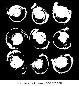 Vector set of grunge brush strokes. White vector brush in a black background. Strokes collection. Grunge stains. Set of brushes design elements, hand drawn with ink.