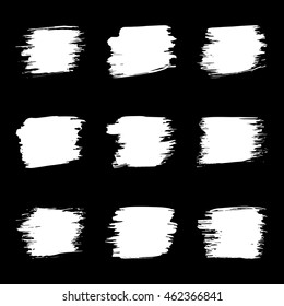 Vector set of grunge brush strokes. White vector brush in a black background. Strokes collection. Grunge stains. Set of brushes design elements, hand drawn with ink.