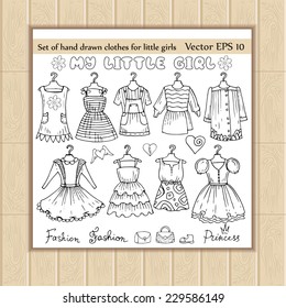 Vector set of hand drawn clothes for little girls. Sketches of clothes for use in design