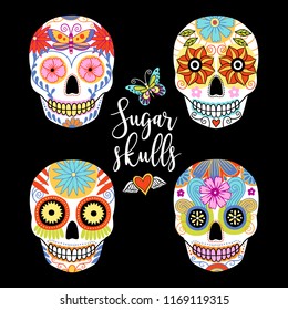 Vector set of hand drawn colorful sugar skulls on black background.