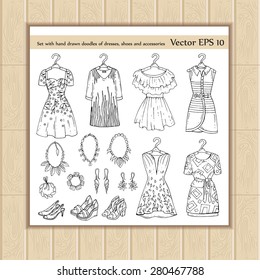 Vector set with hand drawn doodles of fashionable dresses, shoes and accessories for women on white background. Sketches for use in design