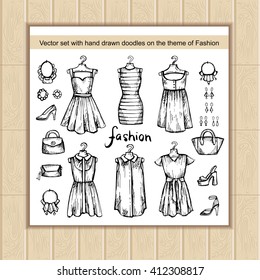 Vector set with hand drawn isolated doodles on the theme of fashion. Flat illustrations of women's clothes. Sketches for use in design, web site, packing, textile, fabric