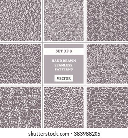 Vector set of hand drawn seamless patterns on brown color. Patterns on the theme of flowers, spring and abstract. Background for use in design, packing, web site, fabric