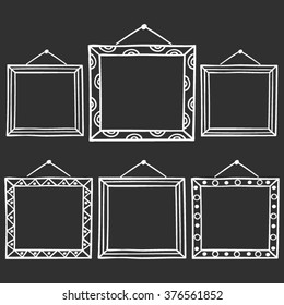 Vector set of hanging picture frames, hand drawn doodle style,   isolated on black background.