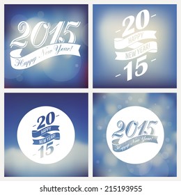 Vector set of Happy 2015 new year greetings | Retro styled happy new year clip art on abstract blurred sky background | Happy new year greeting card decoration elements