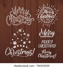 Vector set of holidays lettering. Merry Christmas text for invitation and greeting card, prints, posters. Hand drawn calligraphic design on wood background