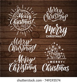 Vector set of holidays lettering. Merry Christmas text for invitation and greeting card, prints, posters. Hand drawn calligraphic design on wood background