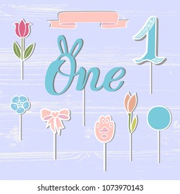 Vector set with One, flowers, paw, ribbon. One handwritten lettering as patch, stick cake toppers, laser cut plastic, wooden toppers. Props for First Year Baby Anniversary, Birthday party.