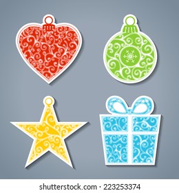 Vector set of paper Christmas stickers. Christmas ball, heart, star and gift for your festive design.