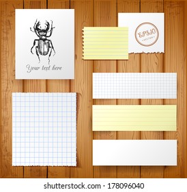 Vector set of paper objects on wood background. Vector illustration.