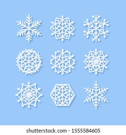 Vector Set of Paper Snowflake shapes. Symmetric Papercut snow flake silhouette isolated on blue. Winter season weather decoration icons. Christmas holiday, Noel greeting card. Origami art snowflakes