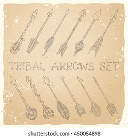 Vector set of sepia ethnic arrows on old paper background. Hand-drawn sepia tribal decorative elements in boho style. Tattoo design.