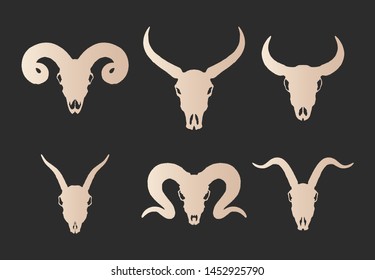 Vector set of six hand drawn gold silhouettes skulls of horned animals: wild buffalo, bull, goat and ram on black background. For you design, print, tattoo or magic craft.