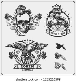 Vector set of tattoo salon labels, badges and design elements. Tattoo studio emblems with professional equipment, skull, eagle and cobra.