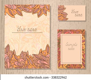 Vector set of templates invitations or greeting cards with decorative floral elements on a wooden background. Collection of templates in orange and pink colors.