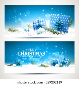 Vector set of two Christmas banners with blue gift boxes, branches and baubles on blue background