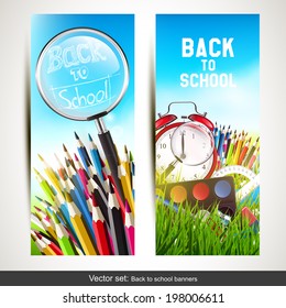 Vector set of two school banners with school supplies in the grass