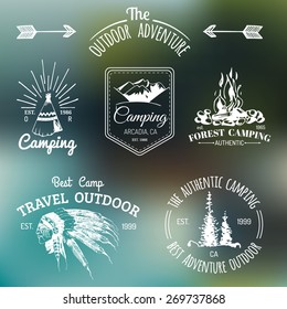 Vector set of vintage camping logos on the blur background. Tourism emblems or badges. Retro signs collection of outdoor adventures with Indian elements.