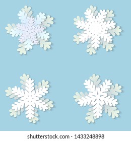 Vector set of white Christmas paper snowflakes with shadow on blue background. Holiday, New year and Christmas design elements