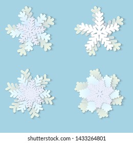 Vector set of white Christmas paper snowflakes with shadow on blue background. Holiday, New year and Christmas design elements