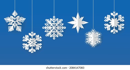 Vector set of white Christmas paper cut 3d snowflakes with shadow on a blue background. New Year and Christmas design elements