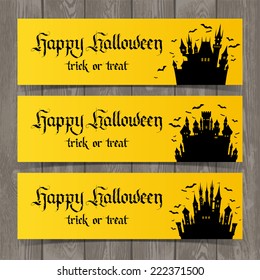 Vector set of yellow cards with castles. Happy Halloween party invitation on wood background. Holidays calligraphic inscription