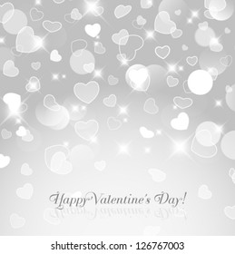Vector shiny hearts bokeh light silver Valentine's day background.