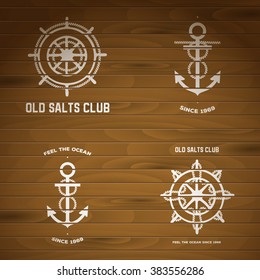 Vector signs of steering wheels and anchors with rope. White logos painted on wood. 