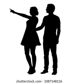 Vector silhouette of boy and girl standing together and pointing finger - isolated on white background
