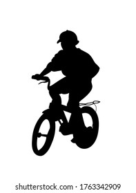  Vector silhouette of a boy on a children's bicycle isolated on a white background.         