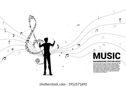 Vector silhouette of conductor with music melody  shape sol key note dancing flow . Concept background for song and concert theme.