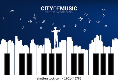 Vector silhouette of conductor with piano key shaped the the big city outline silhouette. Background concept for classic song event and music festival